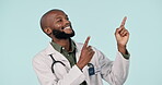 Happy black man, doctor and pointing in advertising or marketing against a studio background. African male person, medical or healthcare professional show notification, alert or information on mockup