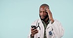 Stress, phone and man doctor in studio doing research for medical treatment on the internet. Headache, frustration and African healthcare worker working on diagnosis on cellphone by white background.
