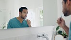 Dental, bathroom mirror and man brushing teeth with toothbrush, toothpaste and home morning treatment. Reflection, enamel care routine and person cleaning mouth for oral shine, hygiene or wellness