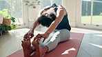 Woman, yoga and stretching body for fitness in living room, wellness with calm and mindfulness at home. Yogi touching toes, health with flexibility for exercise in apartment with peace and self care