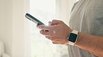 Hands, phone and exercise with a sports person in his home getting ready for training using a smart watch. Mobile, social media and app for fitness tracking with an athlete closeup in his apartment