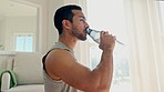 Fitness, drinking water and man in home, workout and training for healthy body. Liquid bottle, thirsty and hydration of athlete, nutrition diet and wellness on break to relax from sports or exercise