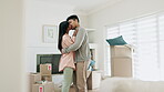 Dancing, couple and kiss to celebrate new home or moving in together with real estate property. A happy man and woman dancer with love in their first house with mortgage, boxes and investment 