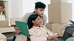 Couple, tablet and laptop in real estate planning, new home or moving in with boxes in property together. Man and woman homeowners on technology in discussion, renovation or relocation plan at house