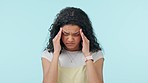 Woman, headache and anxiety, mental health and massage temple from stress isolated on blue background. Wellness, grief and trauma with life crisis, fail or mistake with migraine and pain in studio