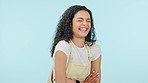 Face, funny and woman with arms crossed, smile and laughing on a blue studio background. Portrait, happy person and model with humor, mockup space and joke with positive mindset, comedy and cheerful