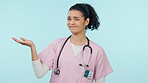 Nurse, pointing and woman, bad medical decision in presentation on blue background. Wrong healthcare tips, disagree with choice and negative feedback in portrait, caregiver with information in studio