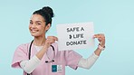 Donate, medical sign and woman face of nurse with poster for blood, organ of healthcare donation in studio. Help, charity work and female person portrait with clinic billboard for advertising