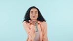 Woman, face and blow kiss in studio for love, romance and happy flirting on blue background. Portrait of model, laugh and kissing air with hands for emoji, funny reaction and date on valentines day 