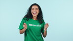 Volunteer, dancing and a woman in studio for excited win, donation and celebration. Fun energy, gen z and happy person volunteering for dancer charity, achievement and success on a blue background