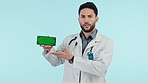 Doctor, phone green screen and presentation, talking of healthcare information, advice or consulting in studio. Face of medical worker on mobile mockup, video results and speaking on blue background