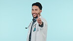 Man, doctor and thumbs up, healthcare support or success, thank you and like emoji on a blue background. Happy face of medical worker with yes, okay and good job emoji for hospital services in studio