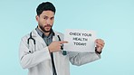 Advertising, poster and man doctor with medical request as professional volunteer isolated in a studio blue background. Pointing, placard and healthcare employee ask for health check announcement
