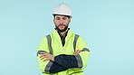 Face, engineer and man with arms crossed in helmet at studio isolated on a blue background mockup space. Portrait, architect and confident professional in hard hat for construction work in Brazil.