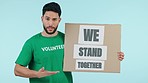 Sign, community service man and volunteer present activism placard, eco support or studio poster for social responsibility. Participation, unity banner or portrait person talking on blue background