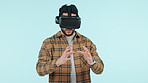 Virtual reality, metaverse and 3D with a man using technology in studio on a blue background. Goggles, software and future gaming with a young person playing esports in cyberspace using an AR app