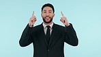 Face, business and man with option, pointing up or opportunity on blue studio background. Portrait, employee or corporate professional with gesture, presentation or mockup space with decision or show