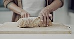 Bread, knife and hands in kitchen, bakery or restaurant for meal prep, dinner or breakfast. Cafe, small business and closeup of person cutting slice of homemade loaf on wooden board for ingredients