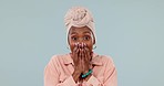 African woman, portrait and excited in studio with hands on mouth for wow surprise, shock or win. Face of black female person with a turban and gesture for success achievement on a blue background
