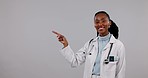 Happy black woman, doctor and pointing in advertising on mockup against a studio background. Portrait of African female person, medical or healthcare worker showing notification, list or information