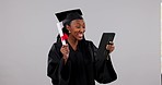 Excited black woman, graduation and tablet dancing in celebration, certificate or winning against a studio background. Happy African female person, student or graduate smile for diploma or technology