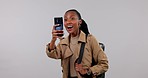 Travel, sightseeing and black woman with phone in studio for pictures to explore, journey and adventure. Photography, happy and African person on gray background for holiday, vacation and tourism