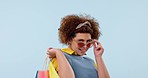 Face, sunglasses and shopping bag of happy woman for fashion in studio isolated on a blue background mockup. Portrait, gift and African customer in boutique, mall or retail store for cool sales deal