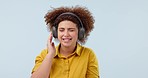 Headphones, happy and young woman in a studio dancing and listening to music, playlist or radio. Smile, technology and female model from Mexico moving and streaming song or album by white background.