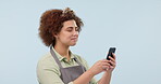 Woman, waitress and smartphone on blue studio background, texting and smiling for social media apps. Laughing, internet and online communication for networking, e-commerce and business text message