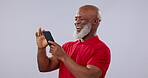 Phone, smile and app with a senior black man in studio on a gray background for communication. Contact, social media and an elderly person laughing at a comic, funny meme or post on his mobile