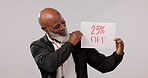 Sale, deal and senior black man with sign for a promotion or poster for giveaway isolated in a studio grey background. Smile, happy and portrait of elderly person with discount or saving announcement