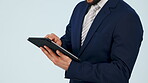 Business man, hands and tablet in studio for planning research, corporate software or internet information. Closeup, worker and scroll on digital technology online, website and app on grey background
