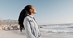 Smile, relax and black woman on beach for holiday on calm tropical island in summer with waves, blue sky and peace. View, nature and happy girl on ocean vacation with freedom, sea water and travel.