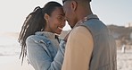 Black couple, embrace and beach with love, bonding and care together by the sea with smile. Happy, freedom and vacation with young people relax with embrace by the ocean on adventure with travel