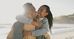 Kiss, happy and black couple at the beach with hug for love, date and bonding on holiday. Laughing, nature and an African man and woman with care and affection at the sea for a vacation or honeymoon