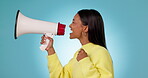 Profile, protest or woman shouting in studio on blue background for freedom on megaphone. Change, news announcement or angry person screaming with loudspeaker for human rights speech or justice 