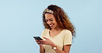 Phone, funny woman typing on social media and reading email on internet. Smartphone, laughing and happy person watch comedy video, meme and joke in studio isolated on a blue background mockup space