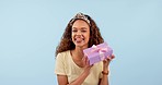 Excited, woman shake present and box in studio isolated on a blue background mockup space. Portrait, happy person guessing gift package and curious at party, birthday celebration and holiday prize