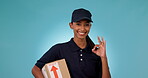 Delivery, perfect sign and portrait of woman courier employee with package isolated in a studio blue background. Ecommerce, logistics and worker with yes hand gesture in agreement with shipping