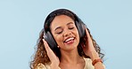 Headphones, sing and young woman in a studio dancing, having fun and listening to music or radio. Happy, smile and female model from Colombia streaming a song, playlist or song by white background.