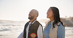 Couple, happy and walking on a beach at sunset for fun vacation, holiday or travel. Asian woman and man together at ocean with interracial love, romance and adventure outdoor to relax by water