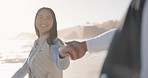 Couple, holding hands and walking on a beach together for fun vacation, holiday or travel. Asian woman pulling a man to follow to ocean with love, romance and adventure outdoor to relax by water