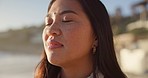 Thinking, calm and face of woman at beach for relaxing on holiday, vacation and weekend outdoors. Travel, nature and person looking at view, sunset and ocean for zen, reflection and peace by sea