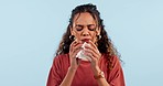 Sneeze, face and sick woman in studio with tissue, paper or flu, allergy or virus infection on blue background. Sinus, problem and lady model blowing nose for hayfever, covid or nasal bacteria risk