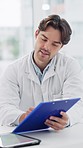 Doctor, checklist and data consultation of a man with clipboard for medical and healthcare advice. Hospital, male professional and writing insurance notes for patient symptoms and paperwork in clinic