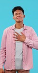 Chest pain, heart attack and man in studio with asthma, stress or heartburn on blue background space. Breathing, problem and face of male model with anxiety, allergy or tuberculosis and indigestion 