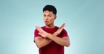 Face, stop and man with arms crossed in protest, rejection or ban in studio isolated on a blue background mockup space. Portrait, warning and prohibition sign of person for caution, wrong and threat