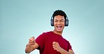 Man, headphones and energy with drums and music, fun and excited with dance on blue background. Happiness, play musical instrument and mockup space, playful and goofy with freedom and tech in studio