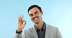 Ok, face and a man with a perfect sign on a studio background for a review, agreement and like. Happy, business and portrait of a corporate employee with a hand gesture for feedback or pride