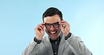 Eye care, portrait and happy man with eyeglasses for vision, focus and frames in studio on blue background. Businessman, face and happiness with consultation at optometrist for eyewear or spectacles